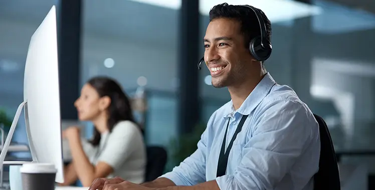 Professional with headset working at a computer